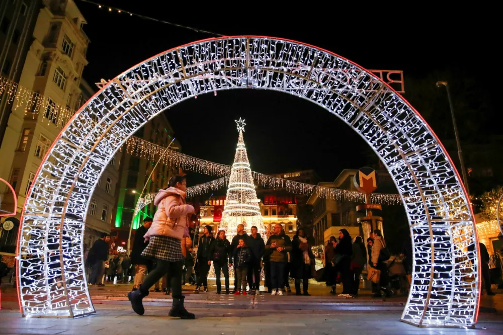 People stroll at the illuminated Sishane Square on New Year's Eve in central Istanbul, Turkey December 31, 2024. REUTERS/Dilara Senkaya