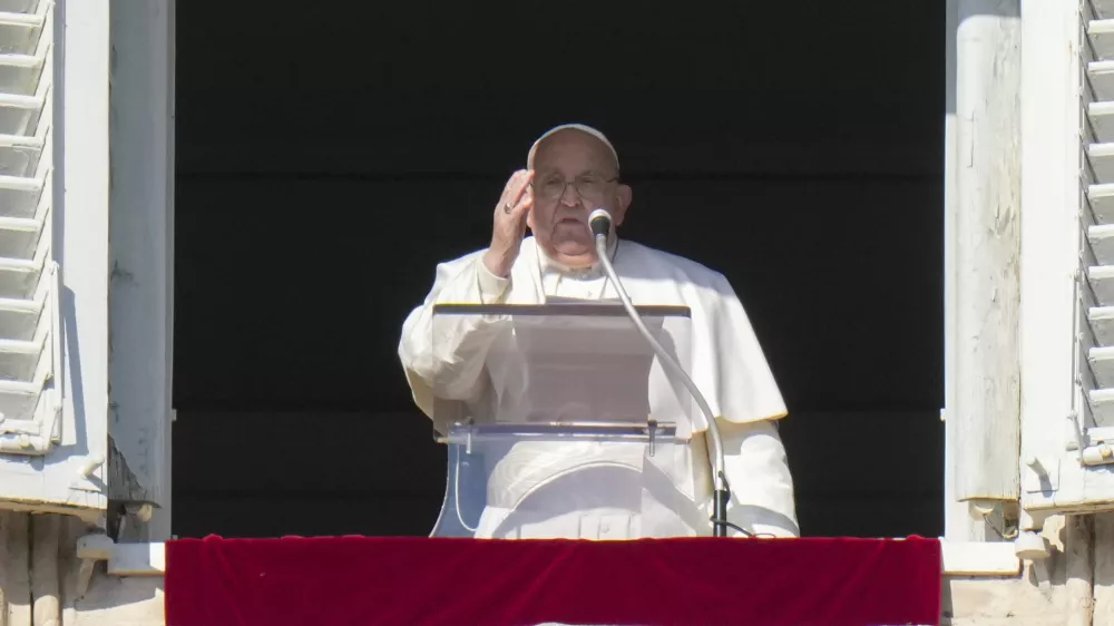 Pope Francis appears at his studio's window overlooking St. Peter's Square at The Vatican to bless pilgrims and faithful after presiding over a mass in St. Peter's Basilica on New Year's Day, Wednesday, Jan. 1, 2025. (AP Photo/Andrew Medichini)