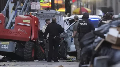 Emergency services attend the scene on Bourbon Street after a vehicle drove into a crowd on New Orleans' Canal and Bourbon Street, Wednesday Jan. 1, 2025. (AP Photo/Gerald Herbert)