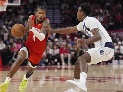 Houston Rockets' Jalen Green (4) drives toward the basket as Dallas Mavericks' Olivier-Maxence Prosper (8 defends during the second half of an NBA basketball game Wednesday, Jan. 1, 2025, in Houston. The Rockets won 110-99. (AP Photo/David J. Phillip)