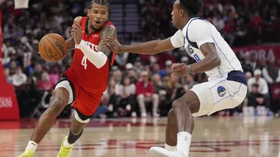 Houston Rockets' Jalen Green (4) drives toward the basket as Dallas Mavericks' Olivier-Maxence Prosper (8 defends during the second half of an NBA basketball game Wednesday, Jan. 1, 2025, in Houston. The Rockets won 110-99. (AP Photo/David J. Phillip)