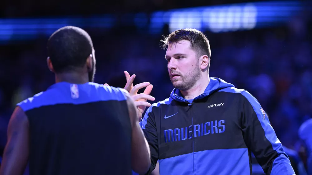 Dec 25, 2024; Dallas, Texas, USA; Dallas Mavericks guard Kyrie Irving (11) greets guard Luka Doncic (77) before the game against the Minnesota Timberwolves at the American Airlines Center. Mandatory Credit: Jerome Miron-Imagn Images