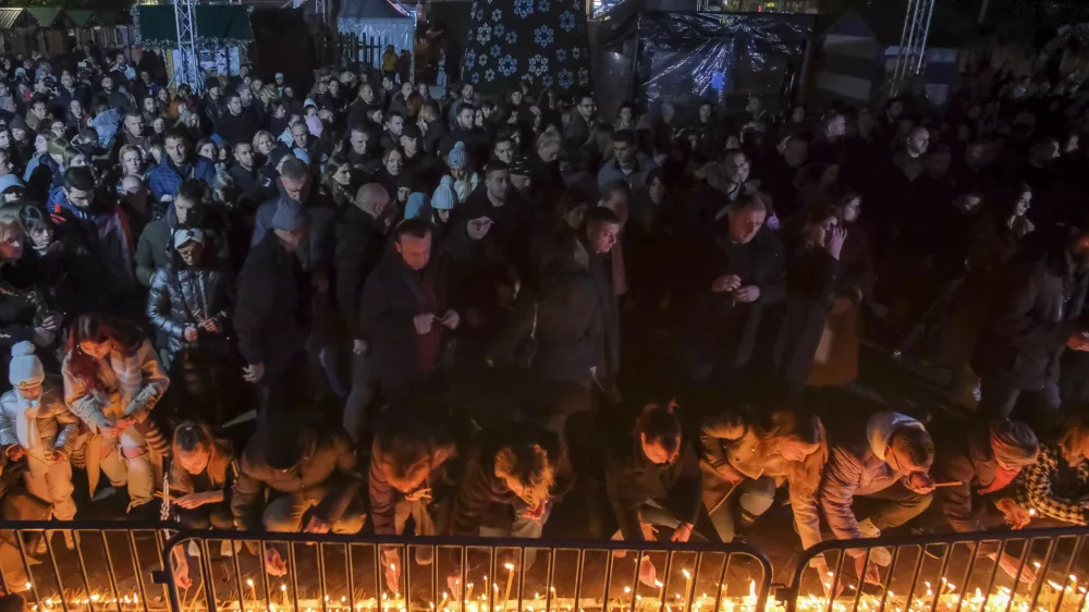 People light candles for the victims of the yesterday's shooting rampage in Cetinje, in Podogrica, Montenegro, Thursday, Jan. 2, 2025. (AP Photo/Risto Bozovic)