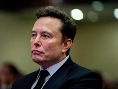 FILE PHOTO: FILE PHOTO: Tesla CEO and X owner Elon Musk listens as US President-elect Donald Trump speaks during a meeting with House Republicans at the Hyatt Regency hotel in Washington, DC, U.S. on November 13, 2024. ALLISON ROBBERT/Pool via REUTERS/File Photo/File Photo