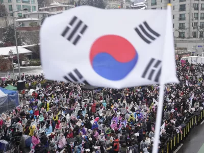 Supporters of impeached South Korean President Yoon Suk Yeol stage a rally to oppose his impeachment near the presidential residence in Seoul, South Korea, Sunday, Jan. 5, 2025. (AP Photo/Ahn Young-joon)