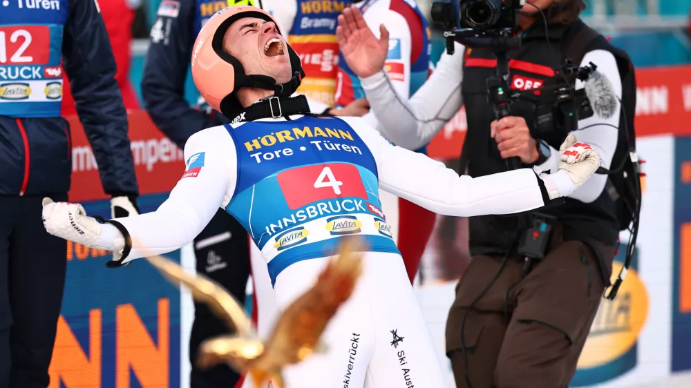 04 January 2025, Austria, Innsbruck: Austria's Stefan Kraft (R) celebrates victory after the men's Large Hill Tournament at the FIS Ski Jumping World Cup. Photo: Daniel Karmann/dpa