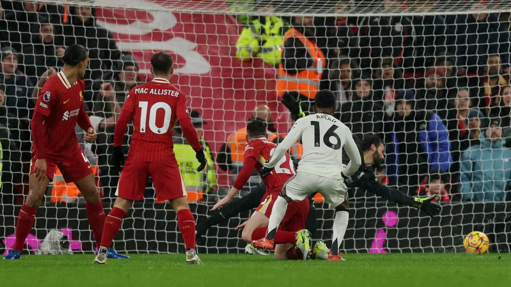 Soccer Football - Premier League - Liverpool v Manchester United - Anfield, Liverpool, Britain - January 5, 2025 Manchester United's Amad Diallo scores their second goal past Liverpool's Alisson Becker REUTERS/Phil Noble EDITORIAL USE ONLY. NO USE WITH UNAUTHORIZED AUDIO, VIDEO, DATA, FIXTURE LISTS, CLUB/LEAGUE LOGOS OR 'LIVE' SERVICES. ONLINE IN-MATCH USE LIMITED TO 120 IMAGES, NO VIDEO EMULATION. NO USE IN BETTING, GAMES OR SINGLE CLUB/LEAGUE/PLAYER PUBLICATIONS. PLEASE CONTACT YOUR ACCOUNT REPRESENTATIVE FOR FURTHER DETAILS..