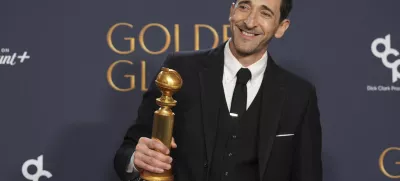 Adrien Brody poses in the press room with the award for best performance by a male actor in a motion picture - drama for "The Brutalist" during the 82nd Golden Globes on Sunday, Jan. 5, 2025, at the Beverly Hilton in Beverly Hills, Calif. (AP Photo/Chris Pizzello)