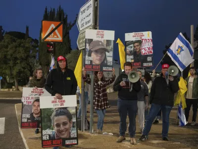 Israeli demonstrators outside the prime minister's office in Jerusalem hold photos of Liri Albag and other hostages during a protest calling for their release from being held in the Gaza Strip by the Hamas militant group, Sunday, Jan. 5, 2025. (AP Photo/Ohad Zwigenberg)