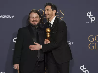 Brady Corbet, winner of the award for best director - motion picture for "The Brutalist", left, Adrien Brody, winner of the award for best performance by a male actor in a motion picture - drama for "The Brutalist", pose in the press room during the 82nd Golden Globes on Sunday, Jan. 5, 2025, at the Beverly Hilton in Beverly Hills, Calif. (AP Photo/Chris Pizzello)