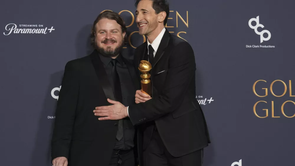 Brady Corbet, winner of the award for best director - motion picture for "The Brutalist", left, Adrien Brody, winner of the award for best performance by a male actor in a motion picture - drama for "The Brutalist", pose in the press room during the 82nd Golden Globes on Sunday, Jan. 5, 2025, at the Beverly Hilton in Beverly Hills, Calif. (AP Photo/Chris Pizzello)