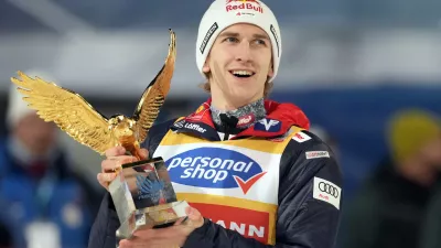 Daniel Tschofenig, of Austria, holds his trophy after winning the 73rd Four Hills ski jumping tournament in Bischofshofen, Austria, Monday, Jan. 6, 2025. (AP Photo/Matthias Schrader)