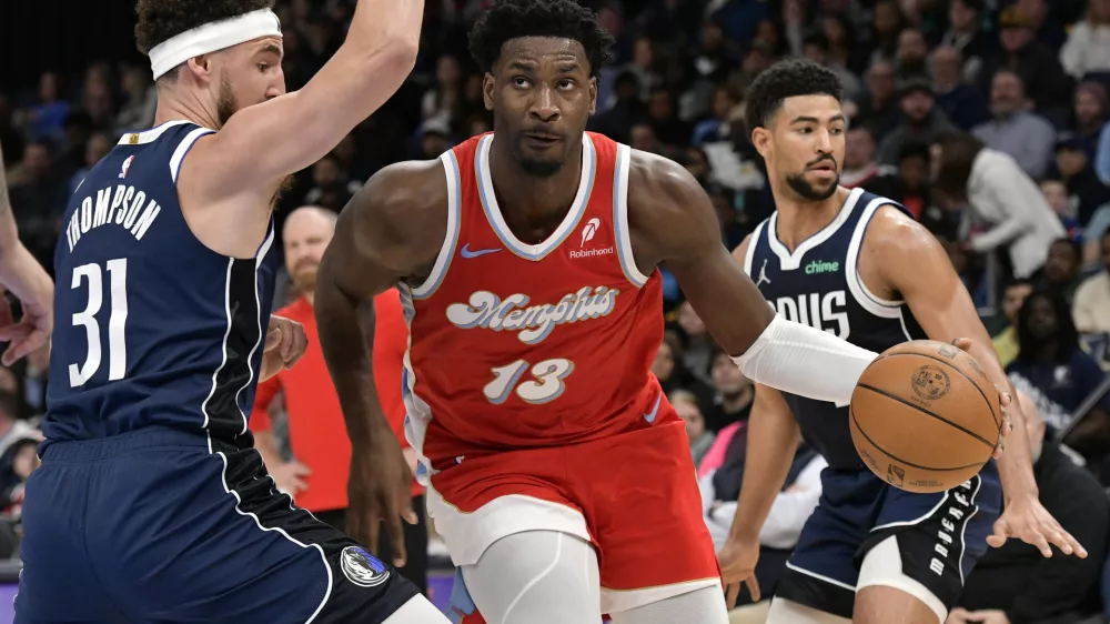 Memphis Grizzlies forward Jaren Jackson Jr. (13) handles the ball against Dallas Mavericks guard Klay Thompson (31) in the first half of an NBA basketball game Monday, Jan. 6, 2025, in Memphis, Tenn. (AP Photo/Brandon Dill)