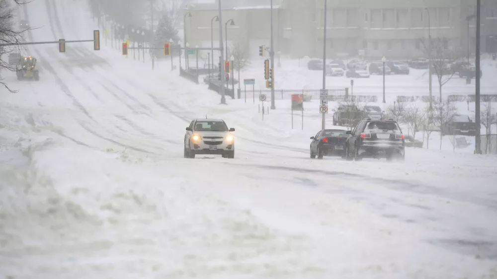 A blizzard hits, warranting a no-travel advisory in much of the region, on Wednesday, Feb. 22, 2023, in Sioux Falls, S.D. Brutal winter weather is hammering the northern U.S. with "whiteout" snow, dangerous wind gusts and bitter cold. (Erin Woodiel /The Argus Leader via AP)