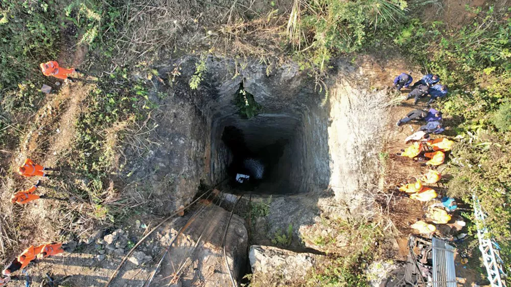 This image provided by Indian Army shows rescue workers standing around a coal mine where at least nine workers are trapped, in Umrangso area of Dimapur Hasao district in northeastern state of Assam, India, Tuesday, Jan. 7, 2025. (Indian Army via AP)