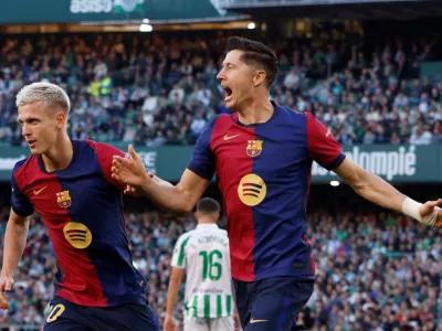 FILE PHOTO: Soccer Football - LaLiga - Real Betis v FC Barcelona - Estadio Benito Villamarin, Seville, Spain - December 7, 2024 FC Barcelona's Robert Lewandowski celebrates scoring their first goal with Dani Olmo REUTERS/Marcelo Del Pozo/File Photo