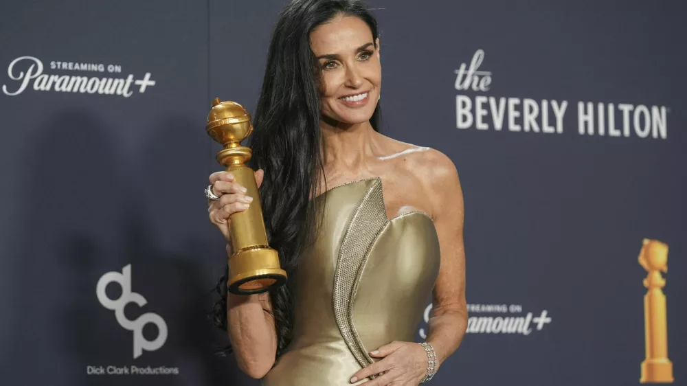 Demi Moore poses in the press room with the award for best performance by a female actor in a motion picture - musical or comedy for "The Substance" during the 82nd Golden Globes on Sunday, Jan. 5, 2025, at the Beverly Hilton in Beverly Hills, Calif. (AP Photo/Chris Pizzello)