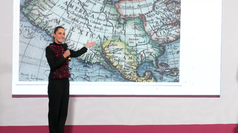 Mexico's President Claudia Sheinbaum shows a 1661 world map showing the Americas and the Gulf of Mexico in response to U.S. President-elect Donald Trump's comments about renaming the body of water, during a press conference at National Palace in Mexico City, Mexico, in this photo distributed on January 8, 2025. Presidencia de Mexico/Handout via REUTERS ATTENTION EDITORS - THIS IMAGE HAS BEEN SUPPLIED BY A THIRD PARTY. NO RESALES. NO ARCHIVES.