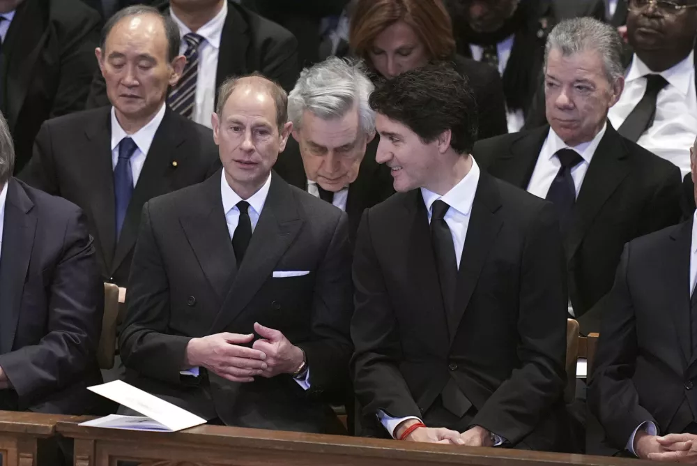 Prince Edward, Duke of Edinburgh, left, talks with Canada's Prime Minister Justin Trudeau before the state funeral for former President Jimmy Carter at Washington National Cathedral in Washington, Thursday, Jan. 9, 2025. (AP Photo/Jacquelyn Martin)