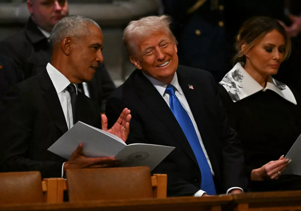 Former U.S. President Barack Obama and U.S. President-elect Donald Trump speak ahead of the state funeral services for former President Jimmy Carter at the National Cathedral on January 9, 2025 in Washington, D.C. Ricky Carioti/Pool via REUTERS