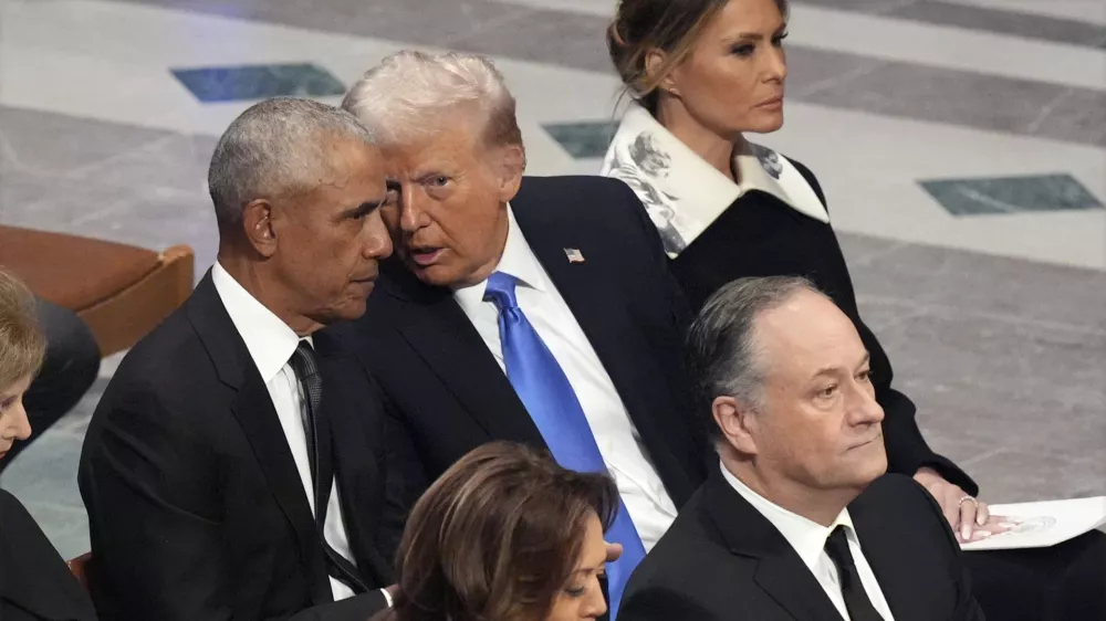 Former President Barack Obama talks with President-elect Donald Trump as Melania Trump listens and as Vice President Kamala Harris and second gentleman Doug Emhoff arrive, before the state funeral for former President Jimmy Carter at Washington National Cathedral in Washington, Thursday, Jan. 9, 2025. (AP Photo/Jacquelyn Martin)