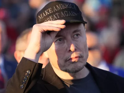 FILE - Tesla and SpaceX CEO Elon Musk listens as Republican presidential nominee former President Donald Trump speaks at a campaign event at the Butler Farm Show, on Oct. 5, 2024, in Butler, Pa. (AP Photo/Alex Brandon, File)