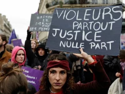 A woman holds a placard as people attend a demonstration to protest against femicide, sexual violence and all gender-based violence to mark the International Day for Elimination of Violence Against Women, in Paris, France, November 23, 2024. The placard reads: "Rapists everywhere justice nowhere". REUTERS/Abdul Saboor