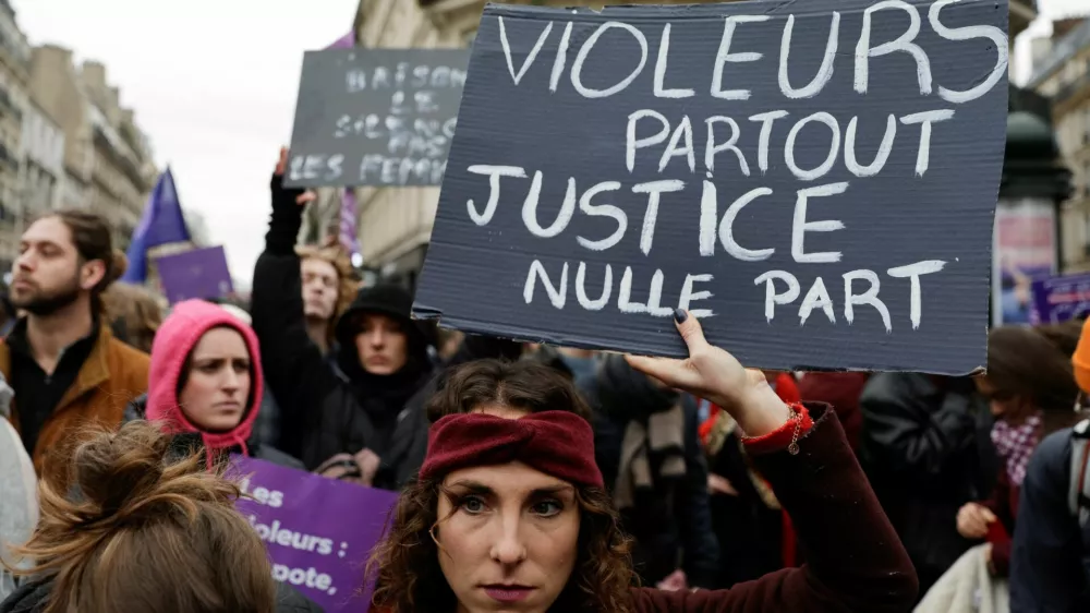 A woman holds a placard as people attend a demonstration to protest against femicide, sexual violence and all gender-based violence to mark the International Day for Elimination of Violence Against Women, in Paris, France, November 23, 2024. The placard reads: "Rapists everywhere justice nowhere". REUTERS/Abdul Saboor