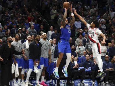 Dallas Mavericks forward P.J. Washington (25) shoots the go ahead three pointer against Portland Trail Blazers guard Shaedon Sharpe (17) in the fourth quarter in an NBA basketball game Thursday, Jan. 9, 2025, in Dallas. (AP Photo/Richard W. Rodriguez)