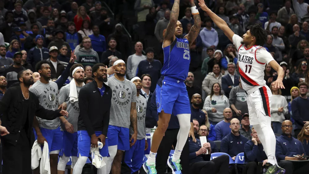 Dallas Mavericks forward P.J. Washington (25) shoots the go ahead three pointer against Portland Trail Blazers guard Shaedon Sharpe (17) in the fourth quarter in an NBA basketball game Thursday, Jan. 9, 2025, in Dallas. (AP Photo/Richard W. Rodriguez)