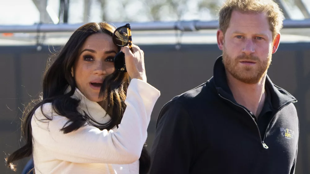 FILE - Prince Harry and Meghan Markle, Duke and Duchess of Sussex visit the track and field event at the Invictus Games in The Hague, Netherlands, Sunday, April 17, 2022. Prince Harry and his wife, Meghan, are expected to vent their grievances against the monarchy when Netflix releases the final episodes of a series about the couple's decision to step away from royal duties and make a new start in America. (AP Photo/Peter Dejong, File)