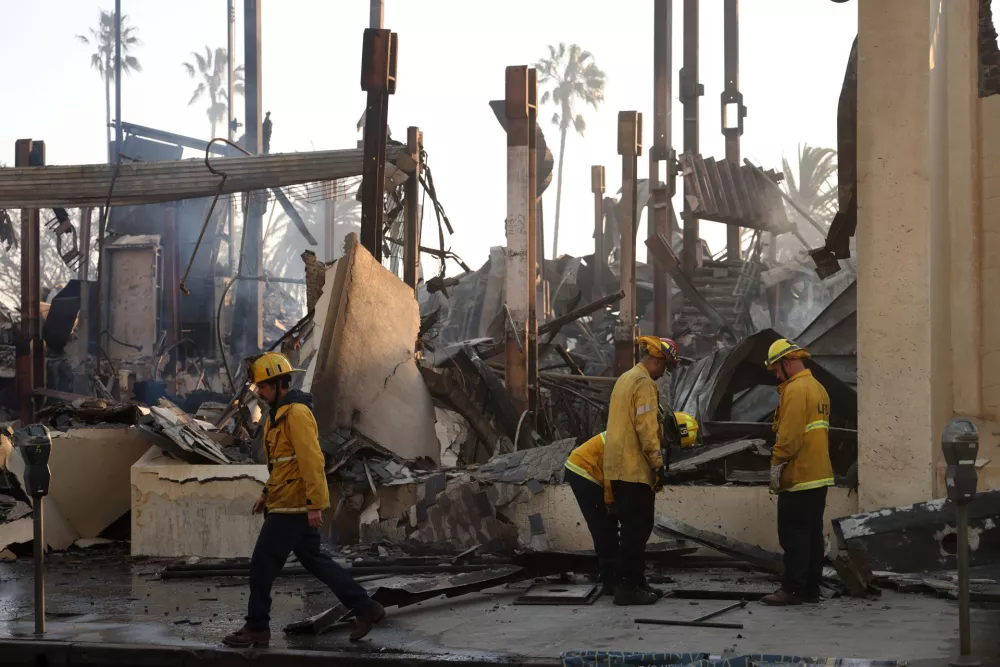 10 January 2025, US, Pacific Palisades: Los Angeles firefighters work at the scene of a business destroyed by the Palisades fire in Pacific Palisades. The fire has burned over 20000 acres and destroyed thousands of structures. Photo: Jonathan Alcorn/ZUMA Press Wire/dpa