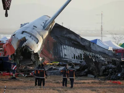 FILE PHOTO: Firefighters take a look at the wreckage of the aircraft that crashed after it went off the runway, at Muan International Airport, in Muan, South Korea, December 31, 2024. REUTERS/Kim Hong-Ji/File Photo