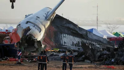 FILE PHOTO: Firefighters take a look at the wreckage of the aircraft that crashed after it went off the runway, at Muan International Airport, in Muan, South Korea, December 31, 2024. REUTERS/Kim Hong-Ji/File Photo