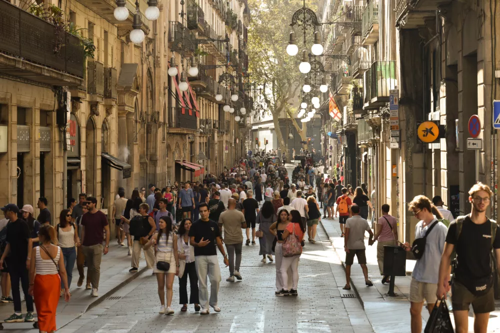 Barcelona, Catalonia- Spain- 10-17-2023: Crowds walk along a pedestrian street near Barcelona's Gothic Quarter.