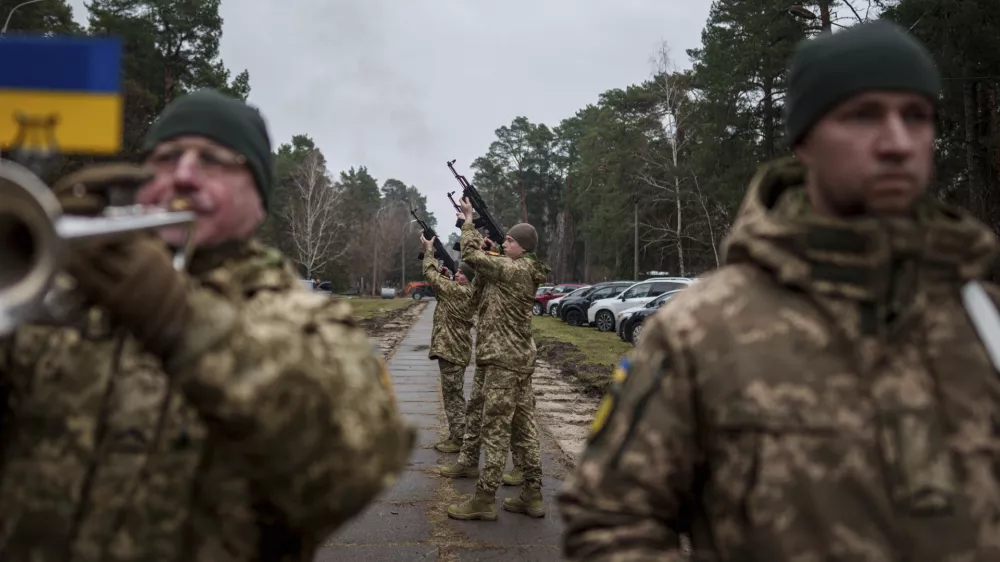 Honour Guard fire into the air during the funeral ceremony of Ukrainian serviceman Andriy Kuzmenko in a cemetery in Kyiv, Ukraine, Friday Jan. 10, 2025. (AP Photo/Evgeniy Maloletka)