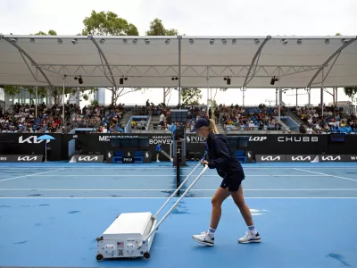 Tennis - Australian Open - Melbourne Park, Melbourne, Australia - January 12, 2025 A member of groundstaff attends to court 3 after rain delayed play REUTERS/Jaimi Joy