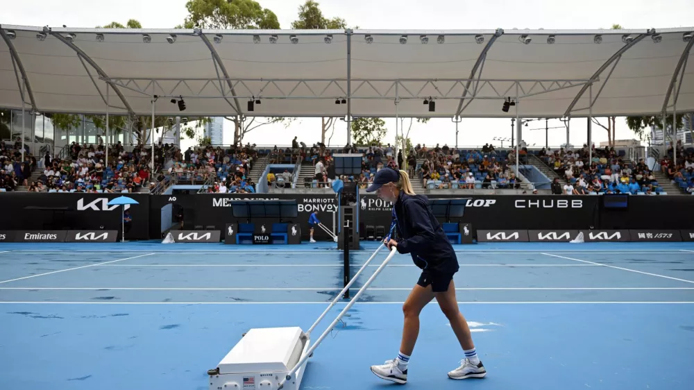 Tennis - Australian Open - Melbourne Park, Melbourne, Australia - January 12, 2025 A member of groundstaff attends to court 3 after rain delayed play REUTERS/Jaimi Joy