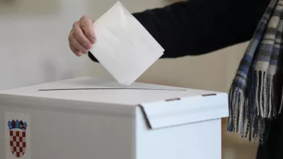 A resident casts his ballot during a runoff vote for the Croatian presidential election at a polling station in Zagreb, Croatia, Sunday, Jan. 12, 2025. (AP Photo/Darko Bandic)