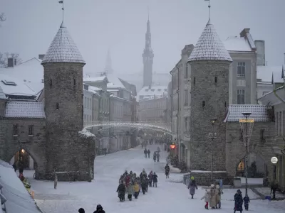 People walk through the snow in Tallinn, Estonia, Friday, Jan. 10, 2025. (AP Photo/Sergei Grits)