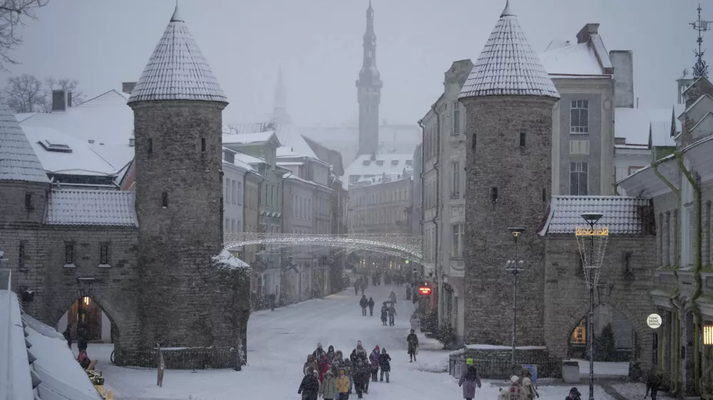 People walk through the snow in Tallinn, Estonia, Friday, Jan. 10, 2025. (AP Photo/Sergei Grits)