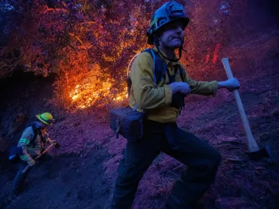 Firefighters extinguish a fire as the Palisades Fire, one of several simultaneous blazes that have ripped across Los Angeles County, burns in Mandeville Canyon, a neighborhood of Los Angeles, California, U.S., January 12, 2025. REUTERS/Ringo Chiu