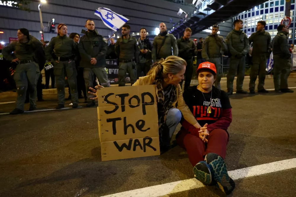 People sit on the ground during a protest against the government and to show support for the hostages who were kidnapped during the deadly October 7, 2023 attack, amid the ongoing conflict in Gaza between Israel and Hamas, in Tel Aviv, Israel January 11, 2025. REUTERS/Kai Pfaffenbach