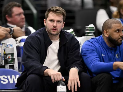 Jan 12, 2025; Dallas, Texas, USA; Dallas Mavericks guard Luka Doncic (77) reacts from the team bench during the second half of the game against the Denver Nuggets at the American Airlines Center. Mandatory Credit: Jerome Miron-Imagn Images