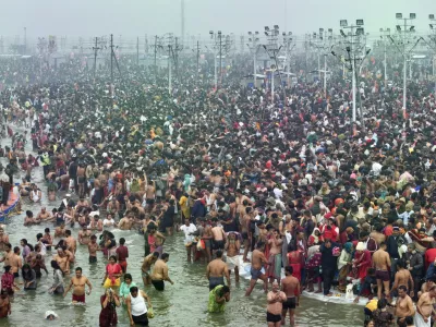 Hindu devotees gather for a dip at the confluence of the Ganges, the Yamuna and the mythical Saraswati rivers on the first day of the 45-day-long Maha Kumbh festival in Prayagraj, India, Monday, Jan. 13, 2025. (AP Photo/Rajesh Kumar Singh)