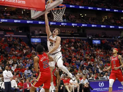 Denver Nuggets forward Vlatko Cancar (31) attempts a layup in front of New Orleans Pelicans guard Trey Murphy III (25) in the second half of an Emirates NBA Cup basketball game in New Orleans, Friday, Nov. 15, 2024. (AP Photo/Tyler Kaufman)