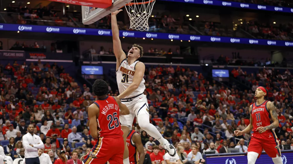 Denver Nuggets forward Vlatko Cancar (31) attempts a layup in front of New Orleans Pelicans guard Trey Murphy III (25) in the second half of an Emirates NBA Cup basketball game in New Orleans, Friday, Nov. 15, 2024. (AP Photo/Tyler Kaufman)