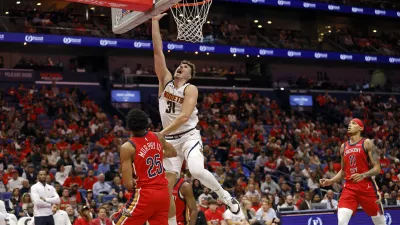 Denver Nuggets forward Vlatko Cancar (31) attempts a layup in front of New Orleans Pelicans guard Trey Murphy III (25) in the second half of an Emirates NBA Cup basketball game in New Orleans, Friday, Nov. 15, 2024. (AP Photo/Tyler Kaufman)