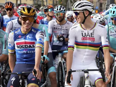 Belgium's Remco Evenepoel, left, and Slovenia's Tadej Pogacar prepare to start the Il Lombardia cycling race in Bergamo, Italy, Saturday, Oct. 12, 2024. (Gian Mattia D'Alberto/LaPresse via AP)