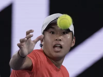 Learner Tien of the U.S. eyes the ball during his second round match against Daniil Medvedev of Russia at the Australian Open tennis championship in Melbourne, Australia, in the early hours of Friday, Jan. 17, 2025. (AP Photo/Ng Han Guan)